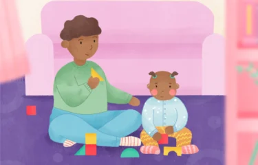 Illustration of an adult and a toddler sitting on a purple carpet in front of a pink couch, playing with colorful building blocks. The adult holds a yellow triangle piece, while the toddler looks focused with blocks in hand.